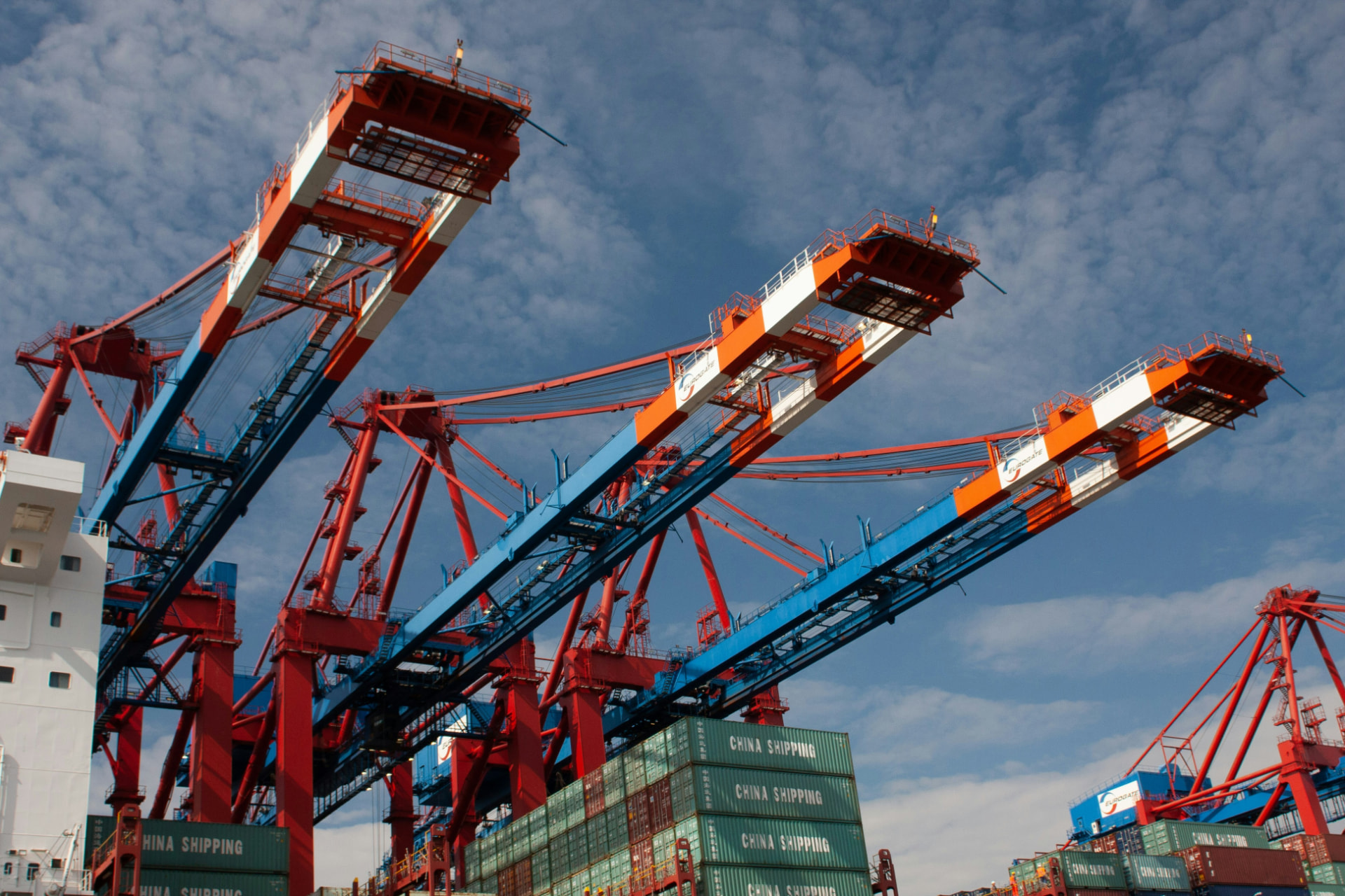 Port cranes and shipping containers, representing established trading businesses